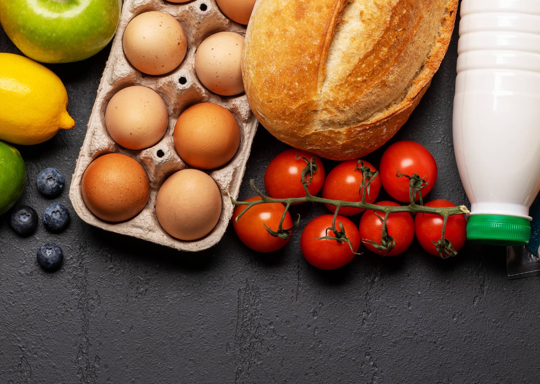 Fresh food items like eggs and tomatoes, representing automated conveyor systems in the food and beverage industry.