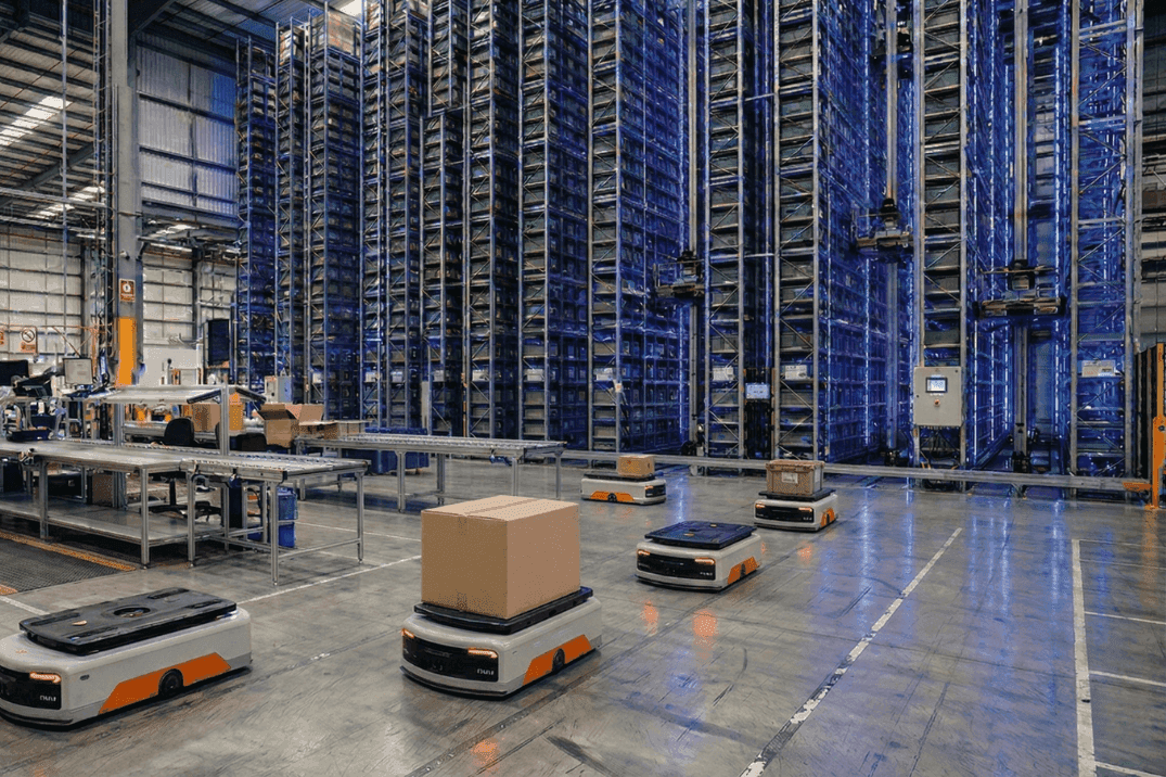 Autonomous mobile robots transporting goods alongside an automated storage and retrieval system in a high-density warehouse, illustrating flexible and scalable automation strategies
