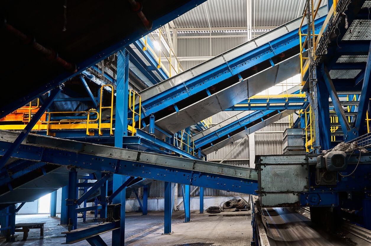 Multiple integrated conveyor belt systems in an industrial facility designed to streamline material flow and minimise operational waste.