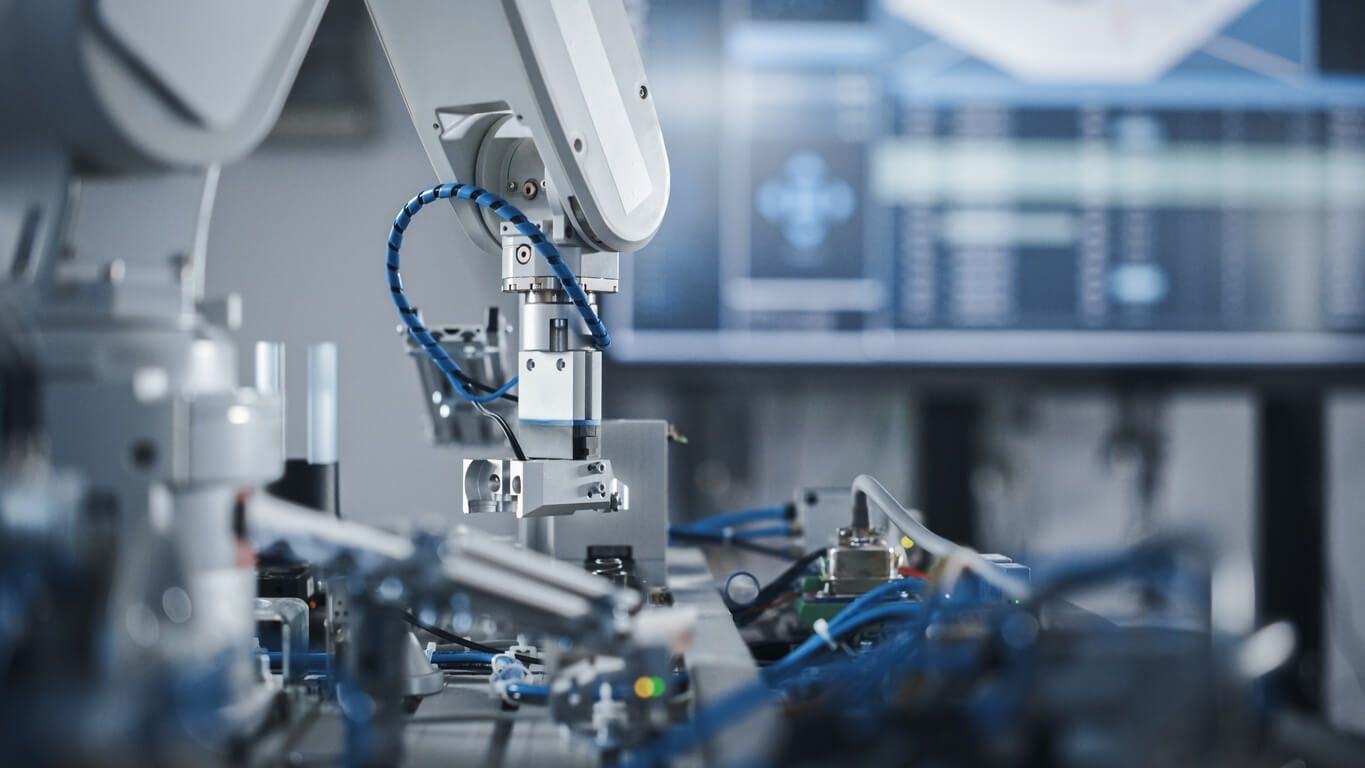 Industrial robotic arm performing precision assembly as part of an automated, energy-efficient manufacturing process