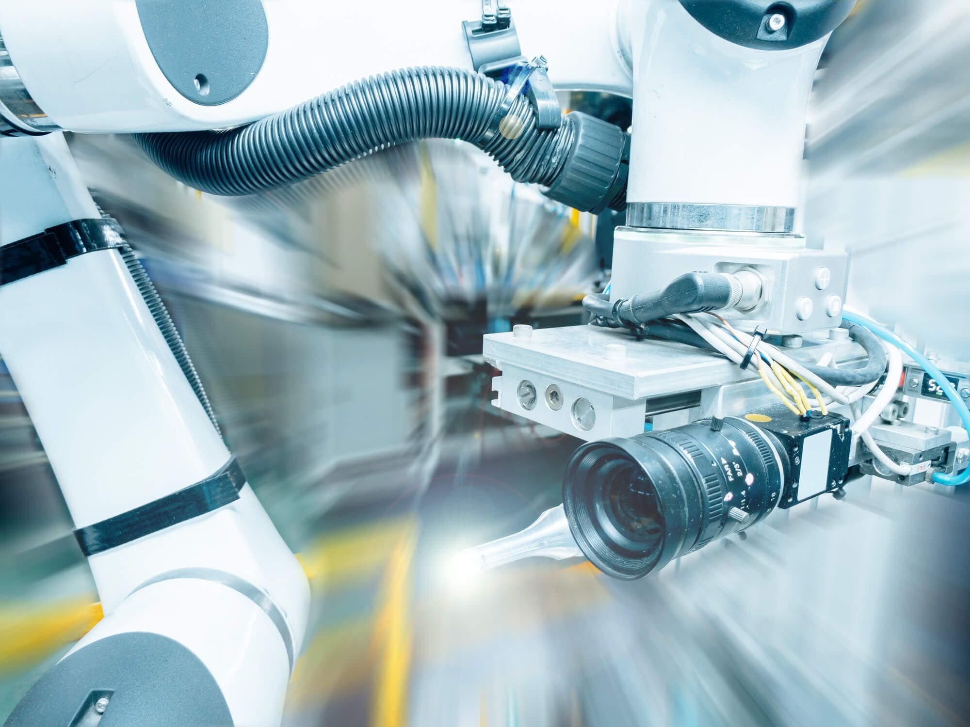 Close-up of vision-guided robotic packaging system with industrial camera supporting real-time inspection and automation integration.