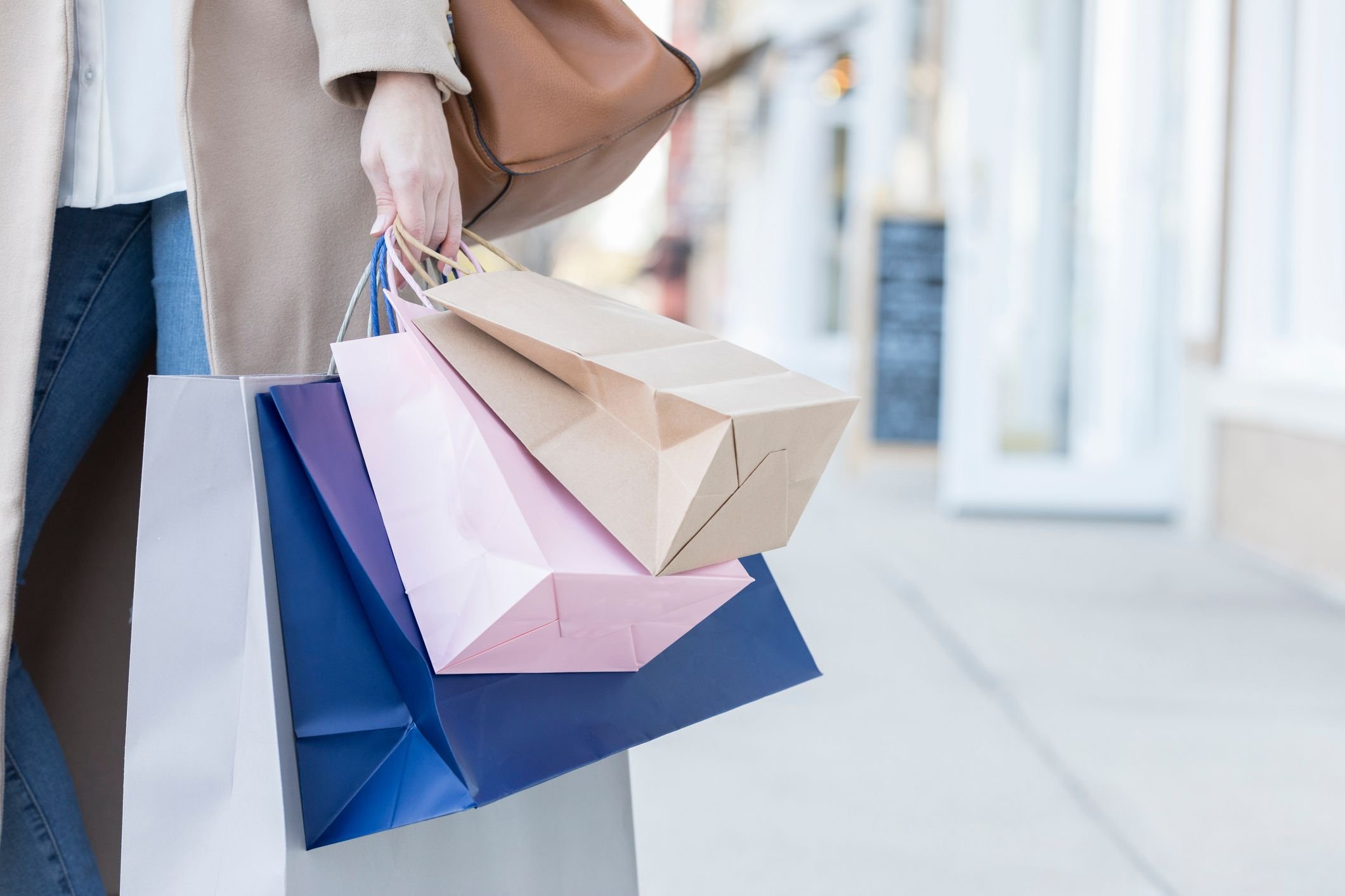 A person holding shopping bags, representing the retail industry